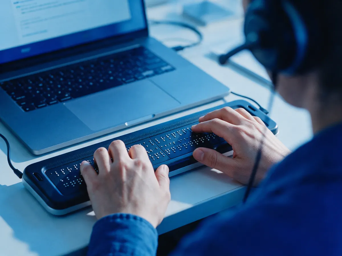 Tester using a braille display and headset