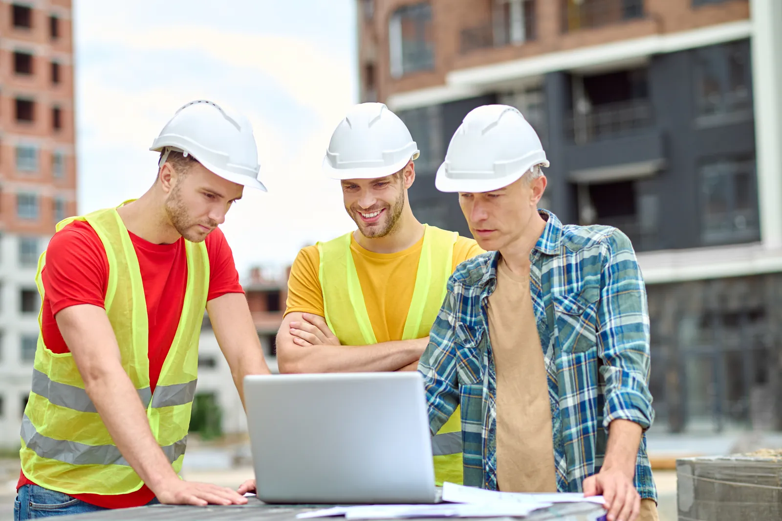 Site team reviewing regression results on a laptop