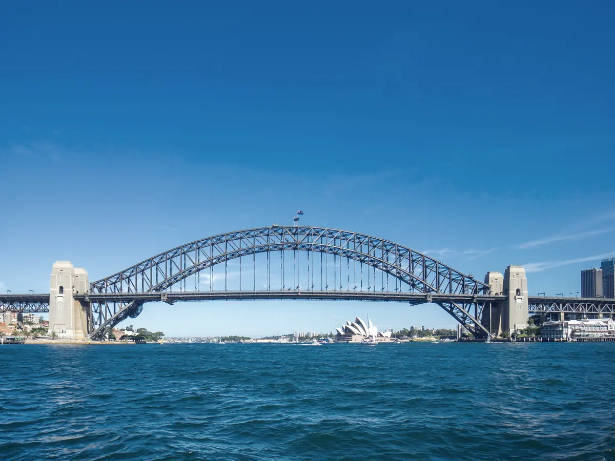 Sydney Harbour Bridge across the harbour, with the Opera House beyond