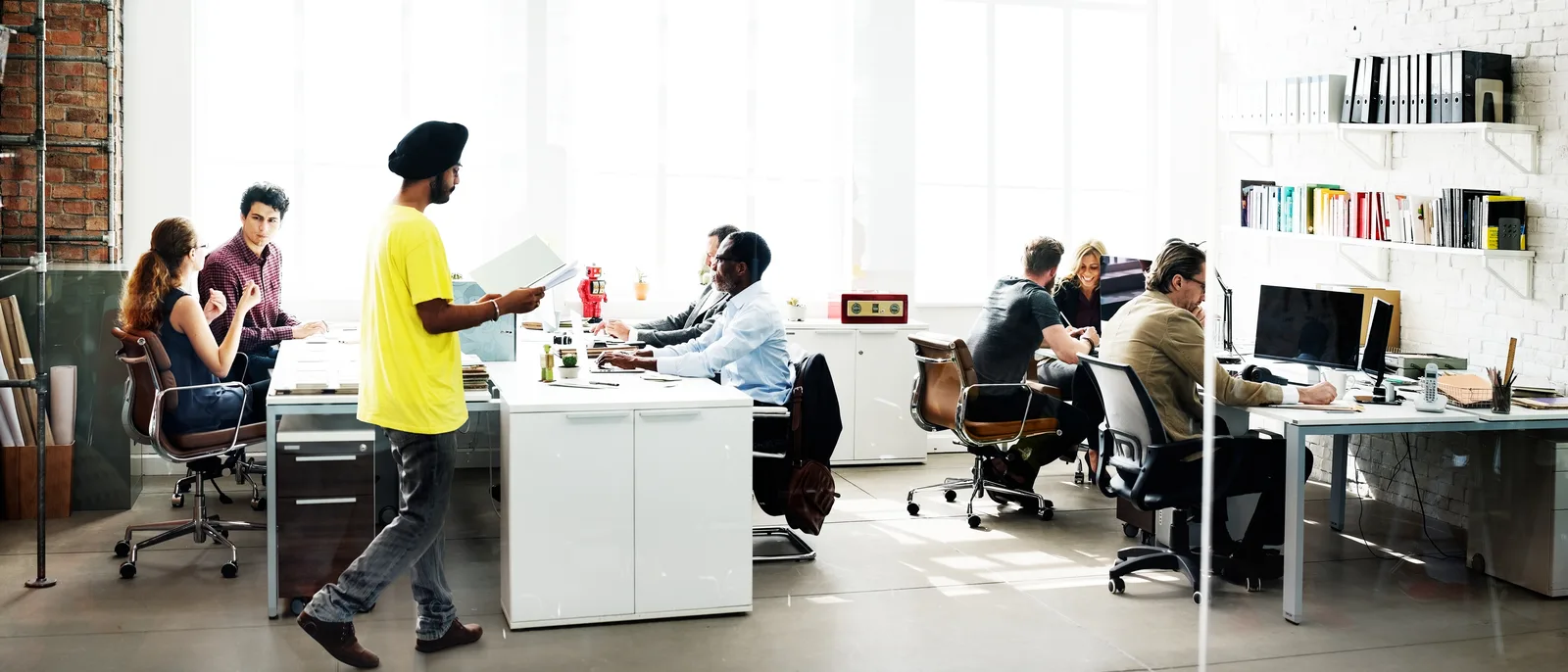 Diverse team working across desks in a bright open-plan office