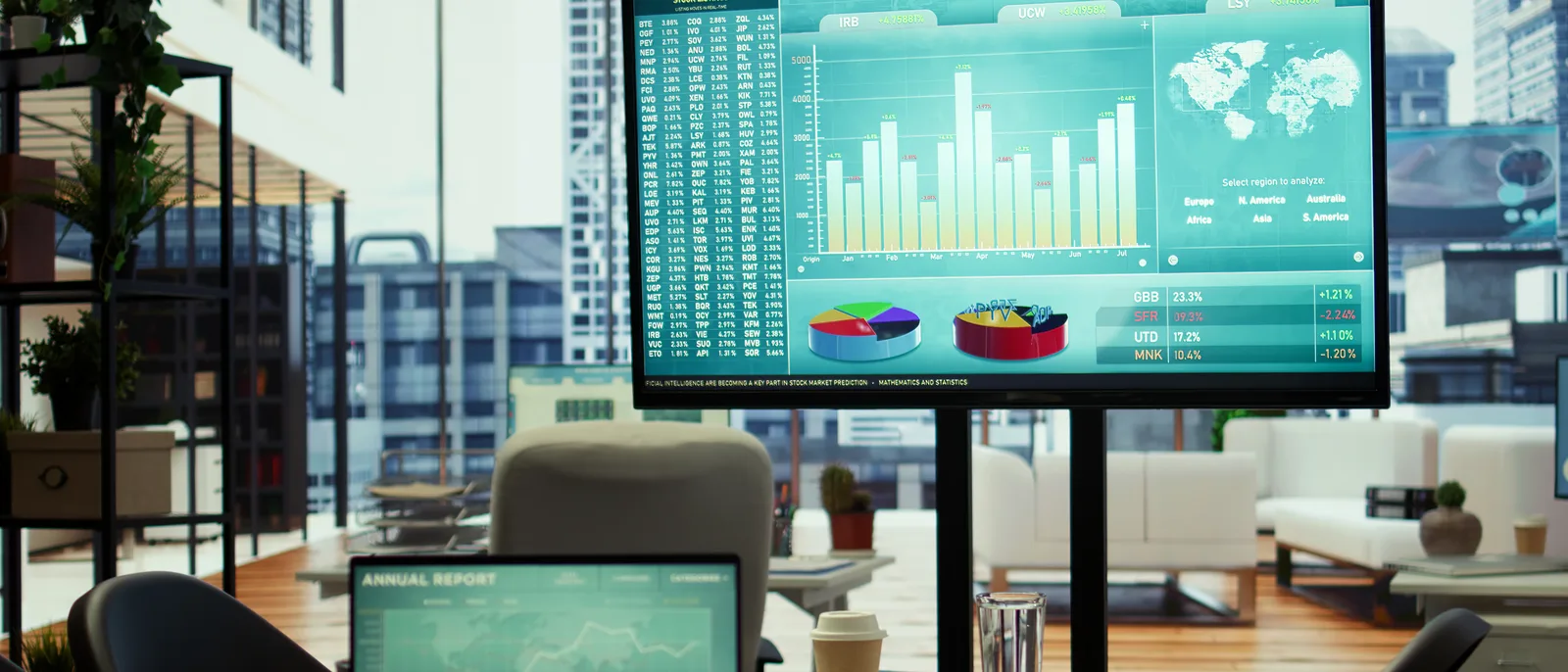 Modern office with a large screen showing data dashboards and charts