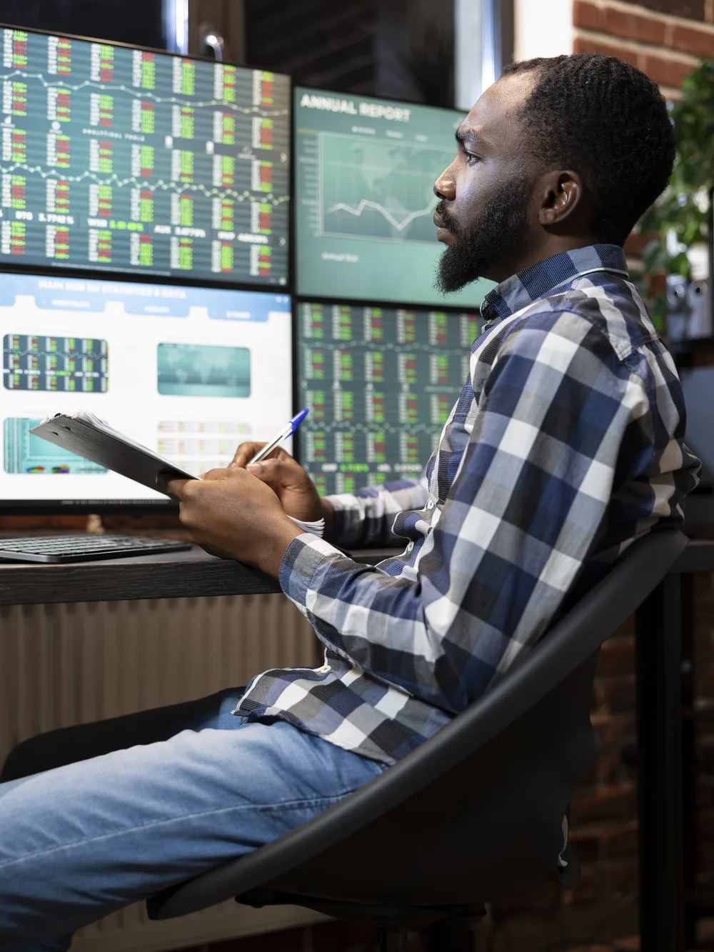 Engineer watching live response-time charts across multiple monitors