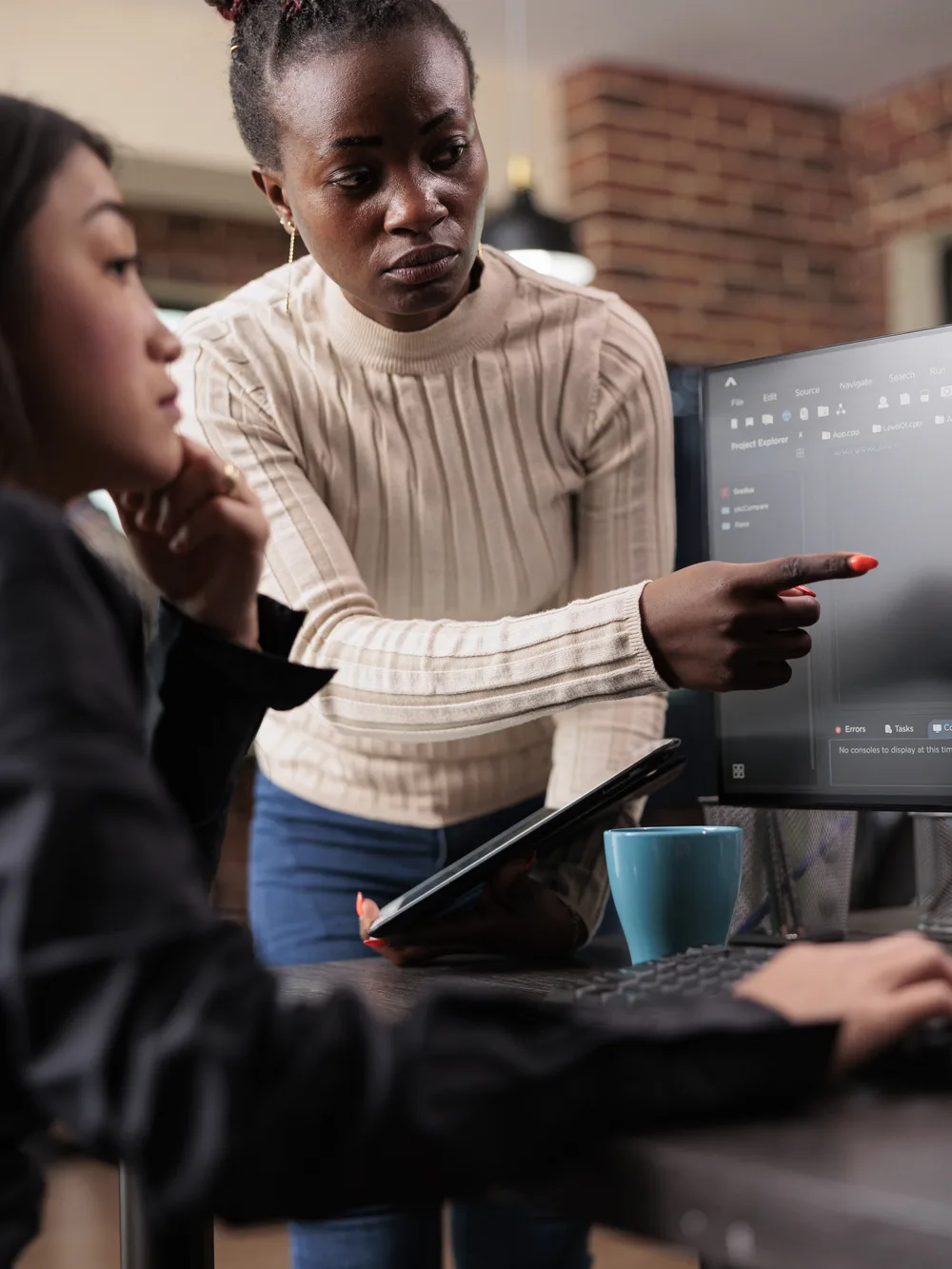 Two developers reviewing a security finding together on screen