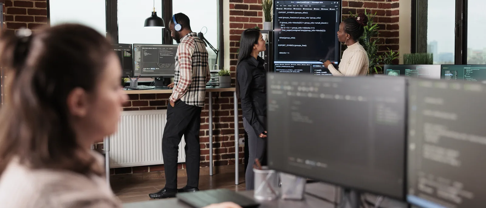 Development team working at multi-monitor desks in an open-plan office