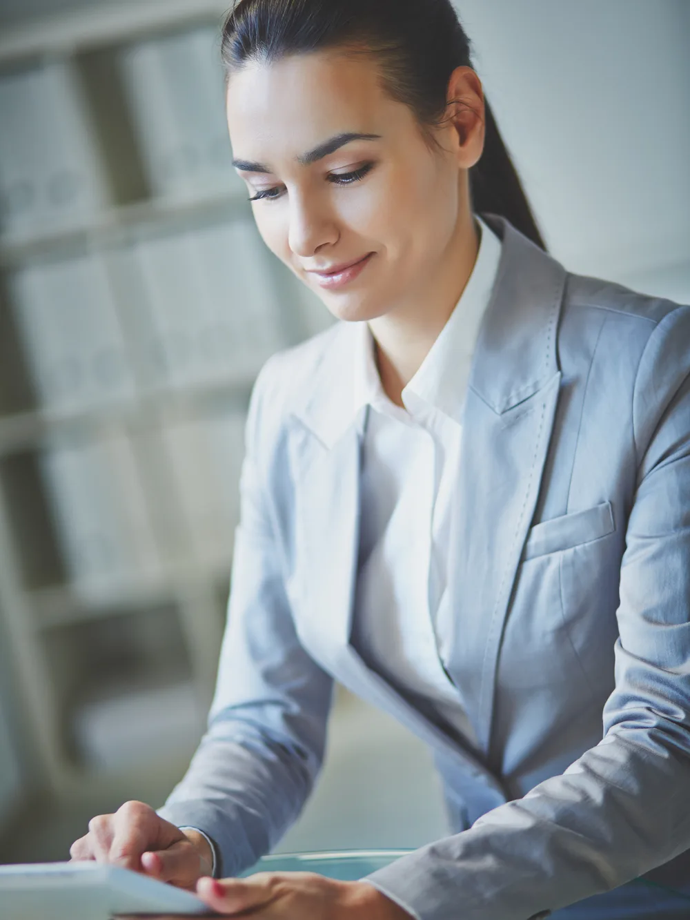 Programme lead reviewing results on a tablet at her desk