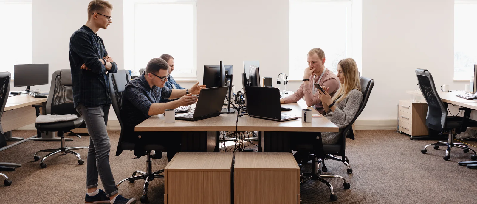 Team working at desks in a bright open-plan office