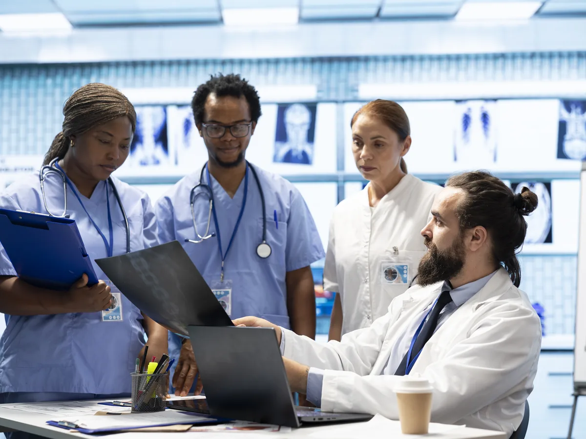 Clinical team reviewing patient data and scans together