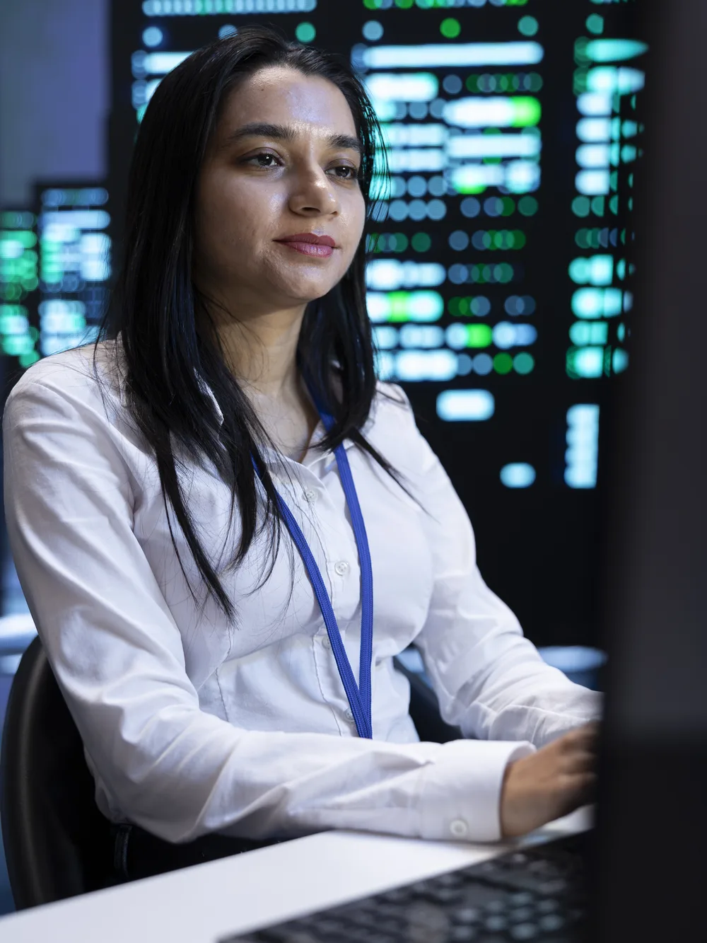 Engineer working at computer in data center control room