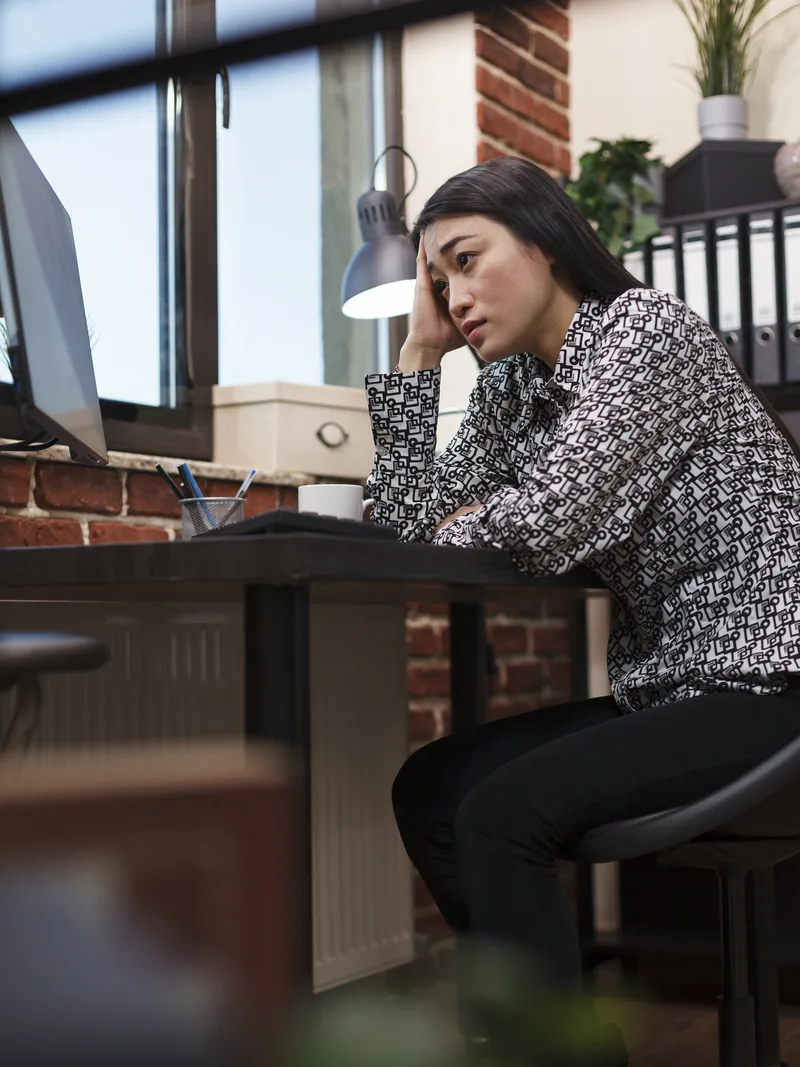 Frustrated businesswoman waiting at her office desk