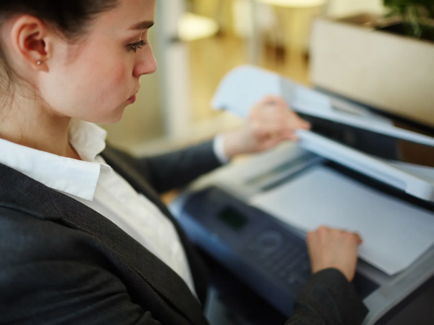 Office worker placing a document on a scanner