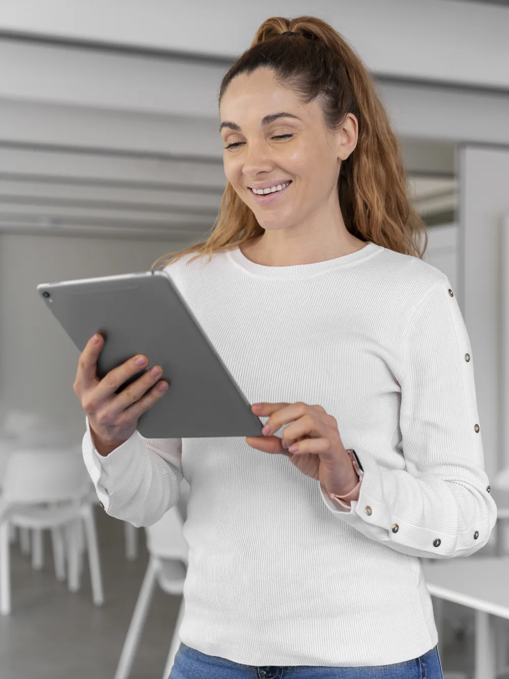 Smiling businesswoman reviewing results on a tablet
