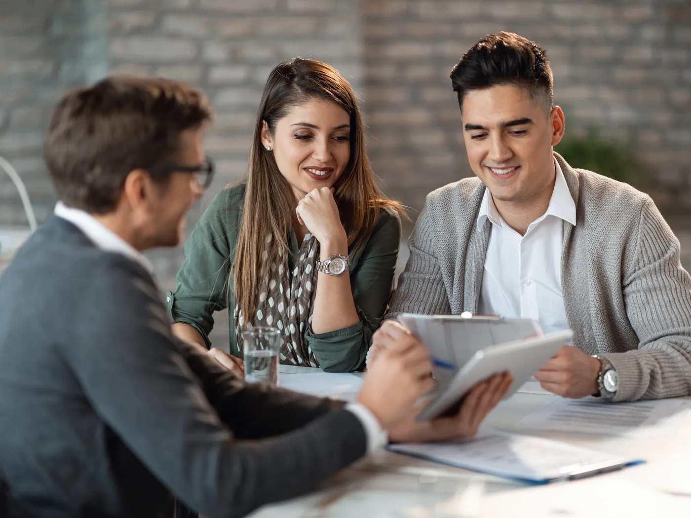 Couple discussing a loan with bank manager