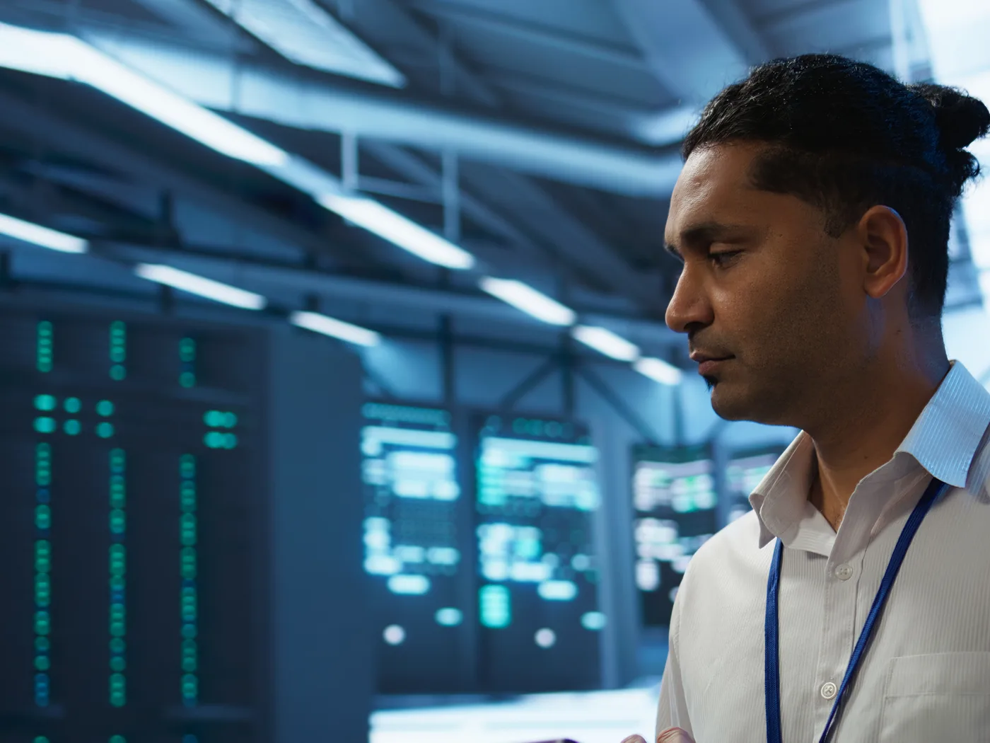 Engineer working beside data centre server racks