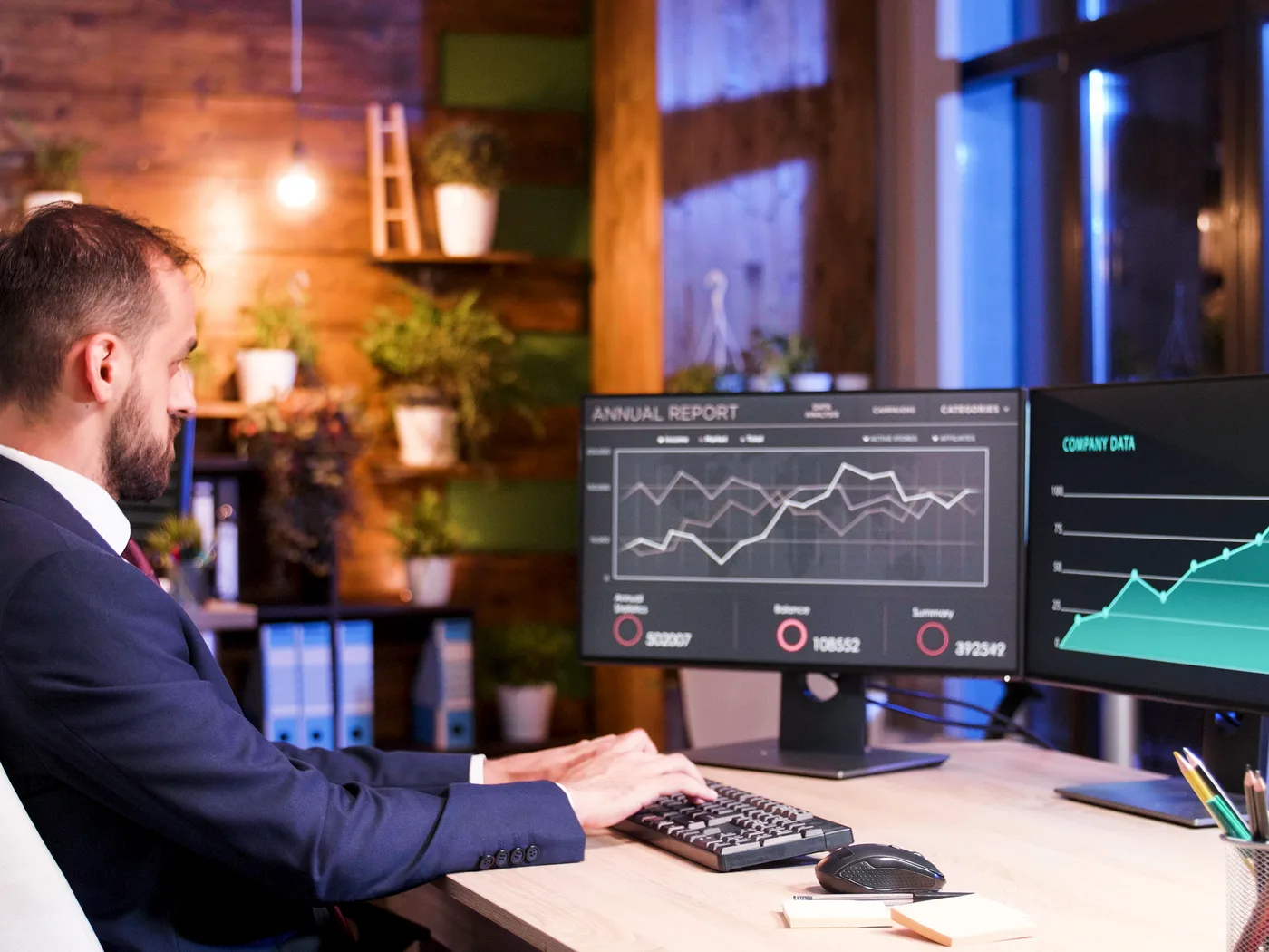 Analyst working late on two monitors