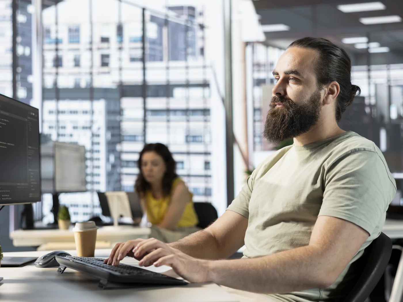 Engineer reviewing code in an open office