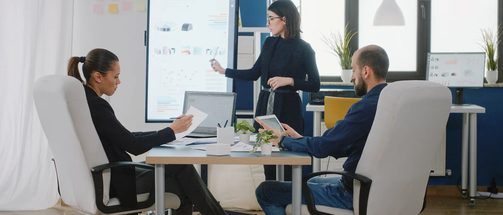 Team meeting around a boardroom presentation screen