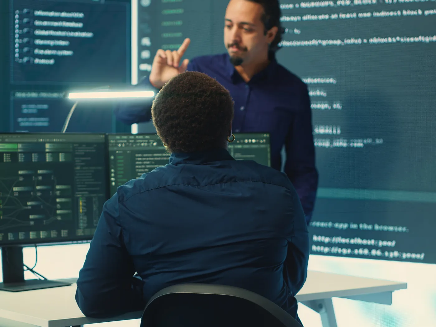 Engineer presenting code on a large screen