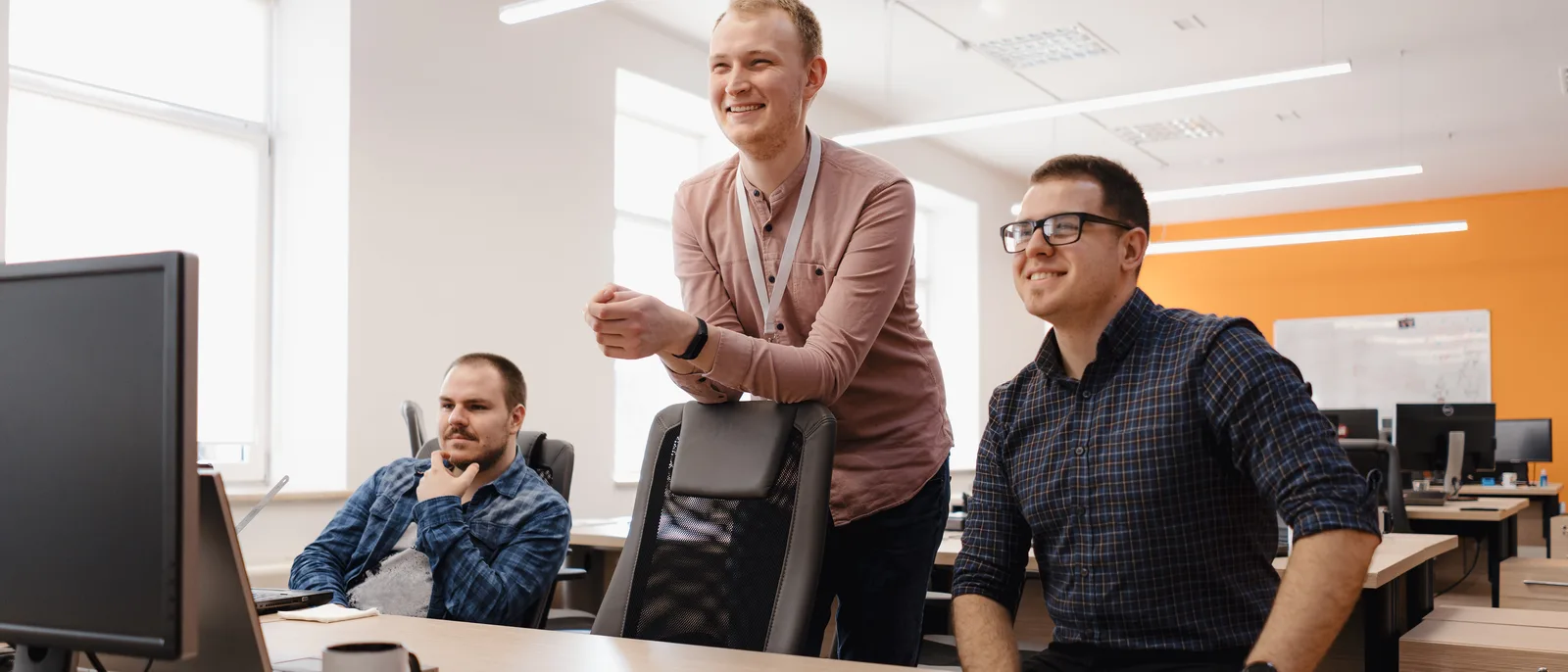 Team talking together in a bright open-plan office