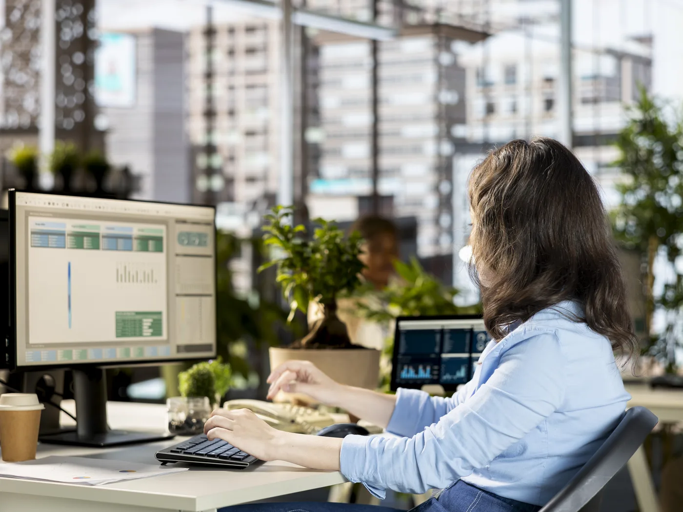 Analyst reviewing data tables on a desktop monitor
