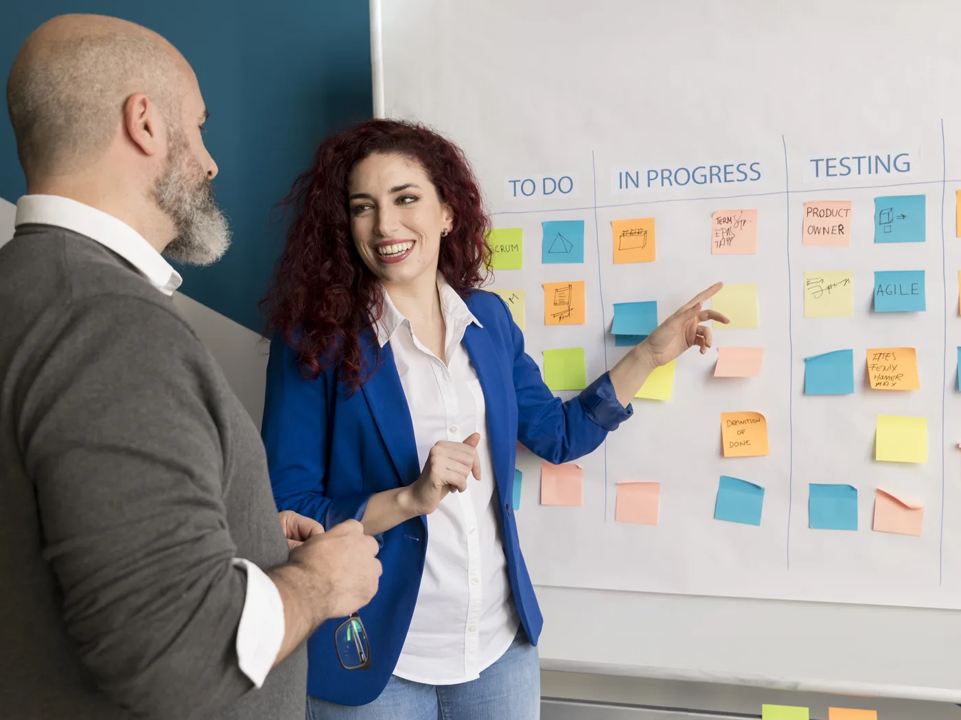 Colleagues updating an agile task board
