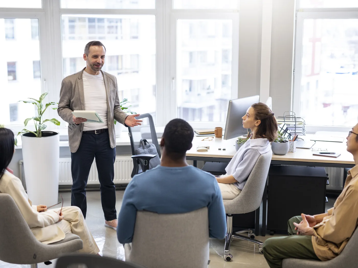 Trainer leading a session in a bright office