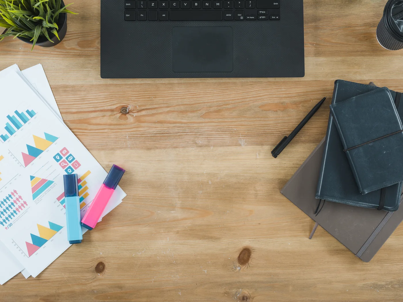 Laptop, reports and notebooks on a desk