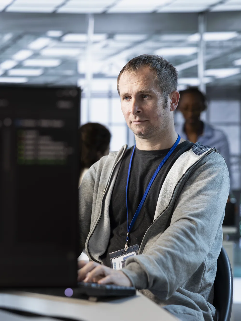 Developer at workstation in server operations room