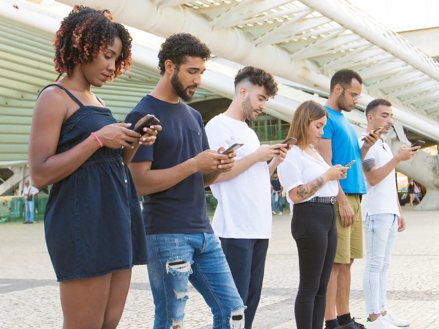 Group of people all using smartphones at once