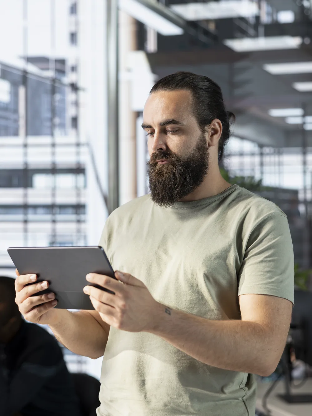 Developer checking a tablet in a modern office