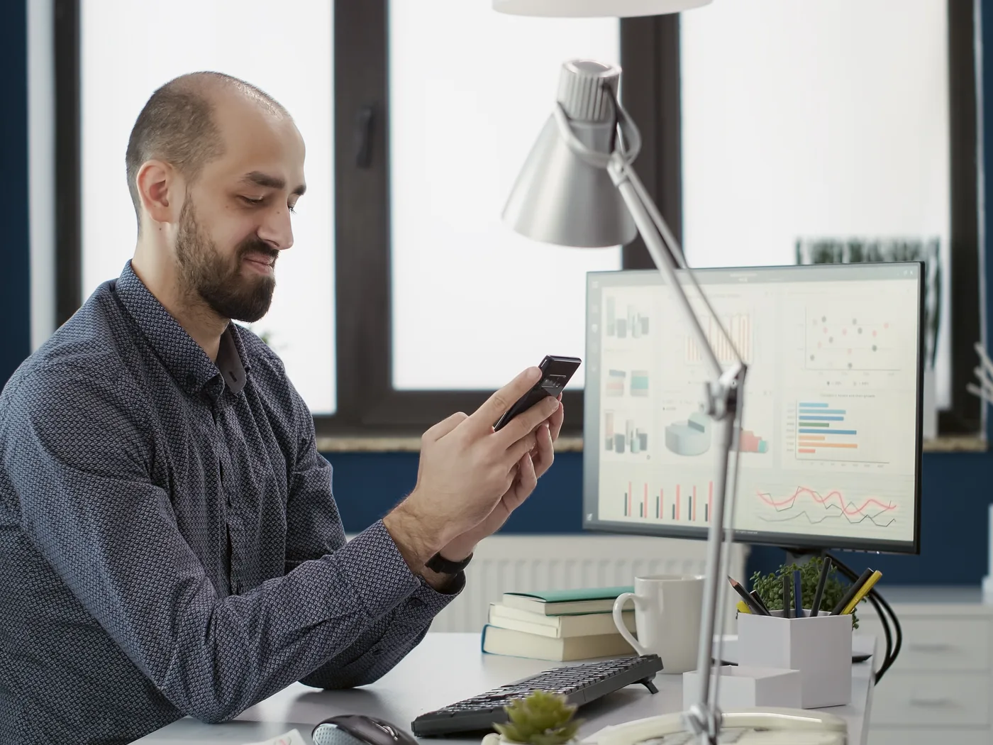 Man checking an app with charts on screen