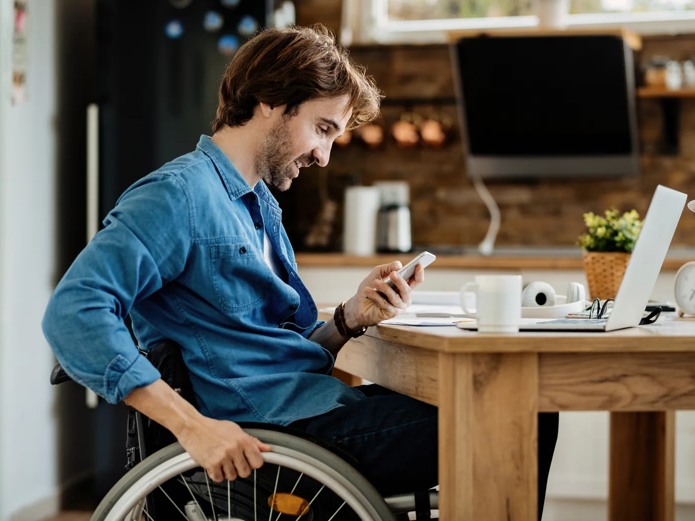 Man in a wheelchair using his smartphone