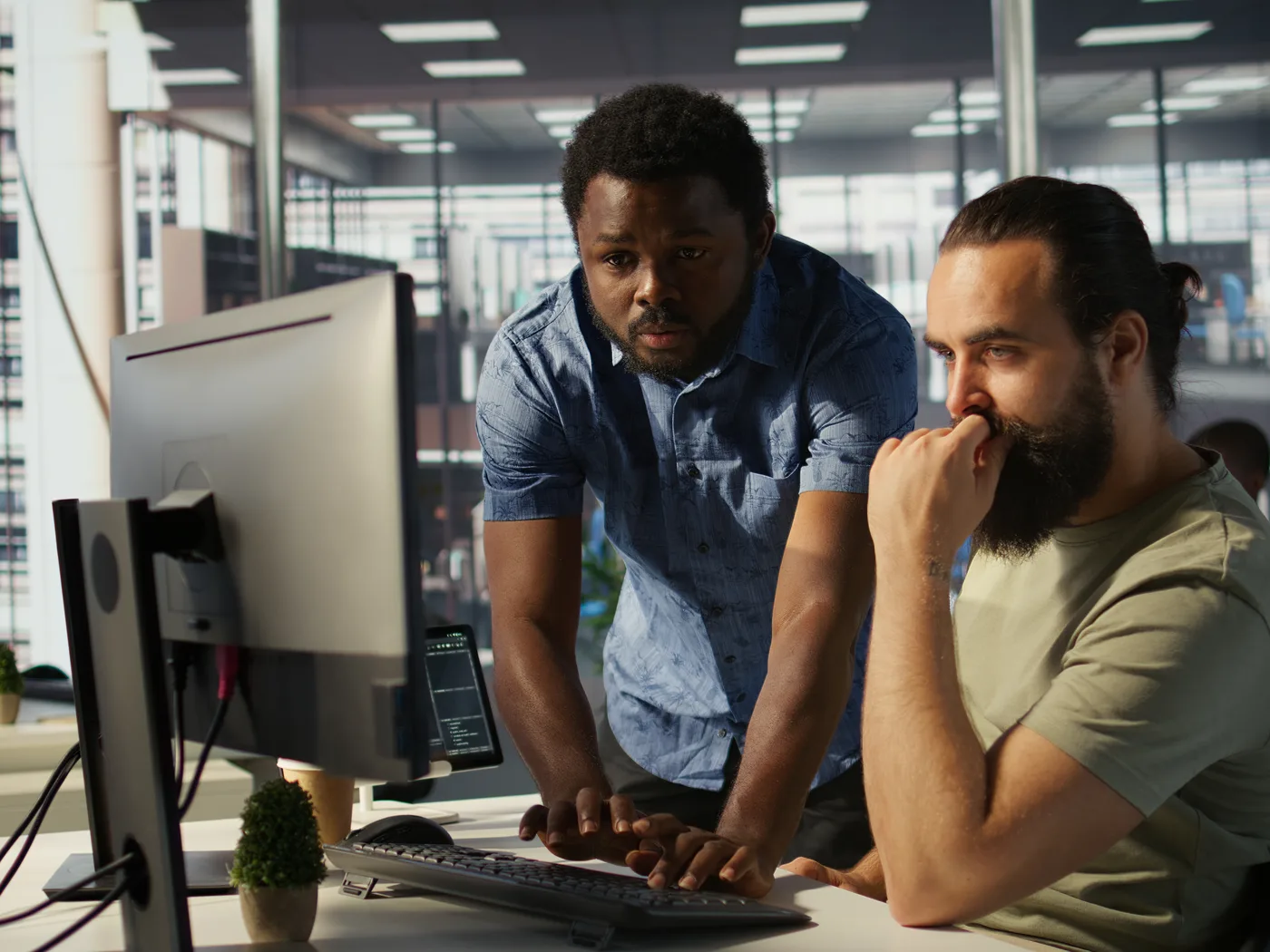 Two engineers checking results together at a workstation