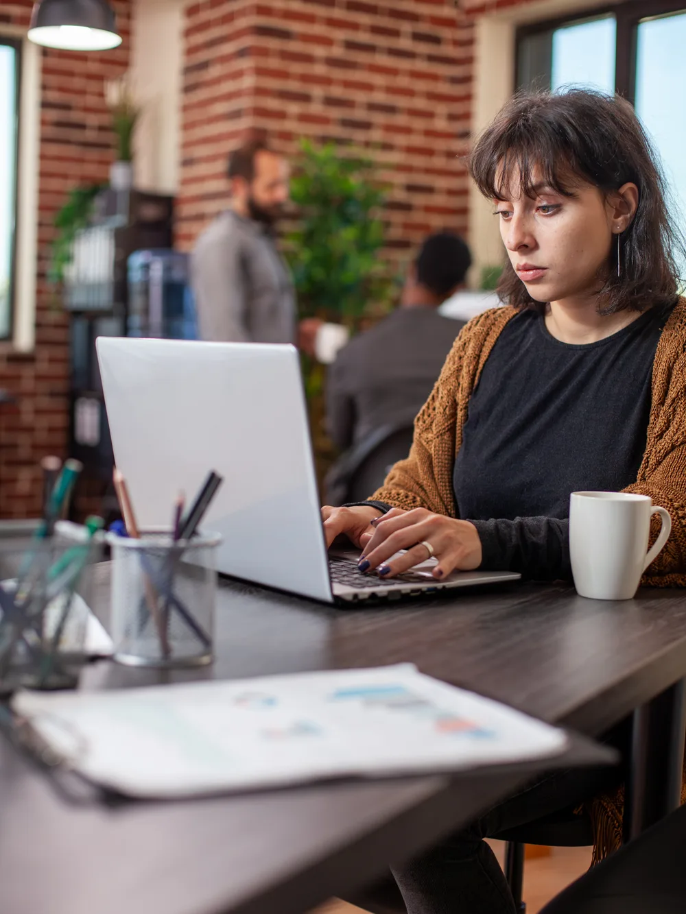 Woman working on laptop in modern office