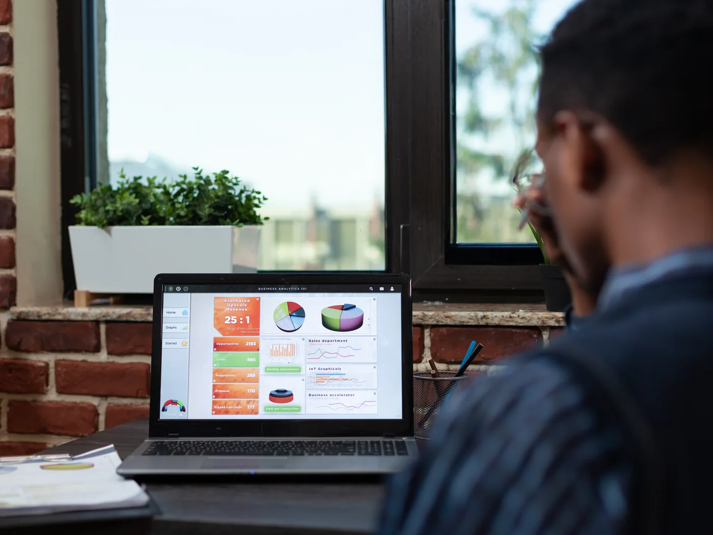 Analyst examining charts on laptop screen