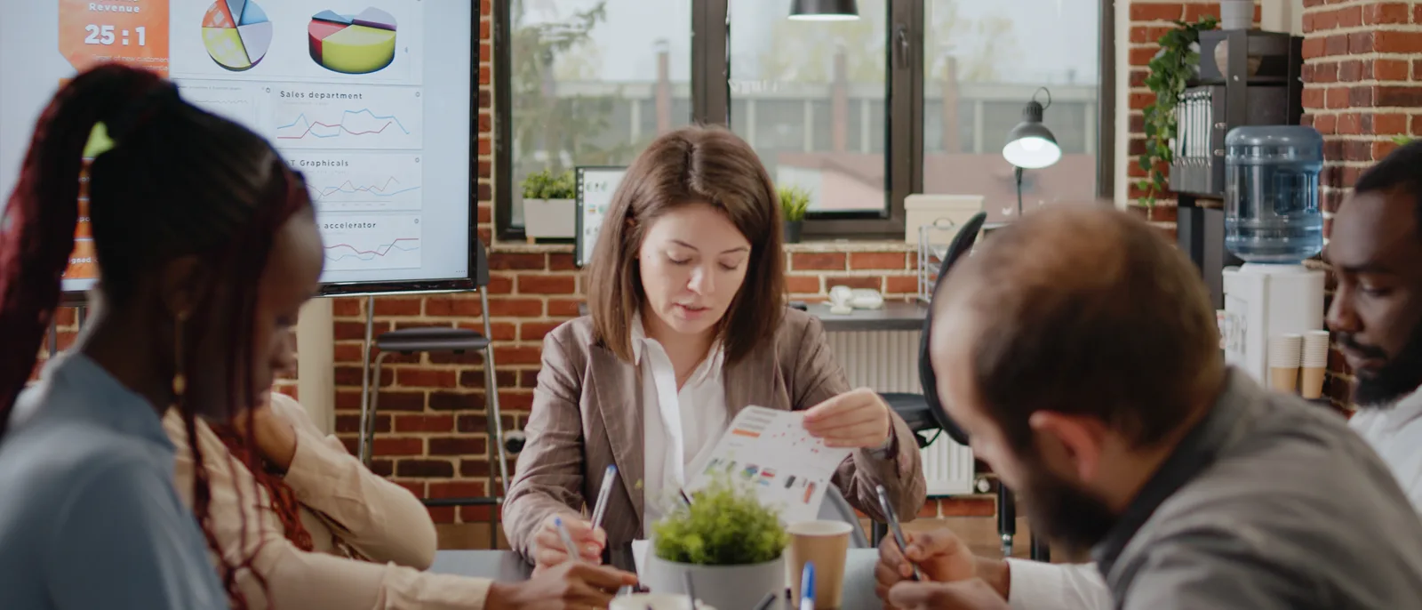 Team discussing results around a meeting table in a bright office