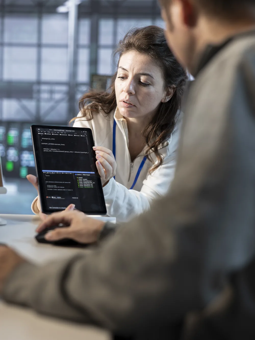 Engineers reviewing test code on a tablet together