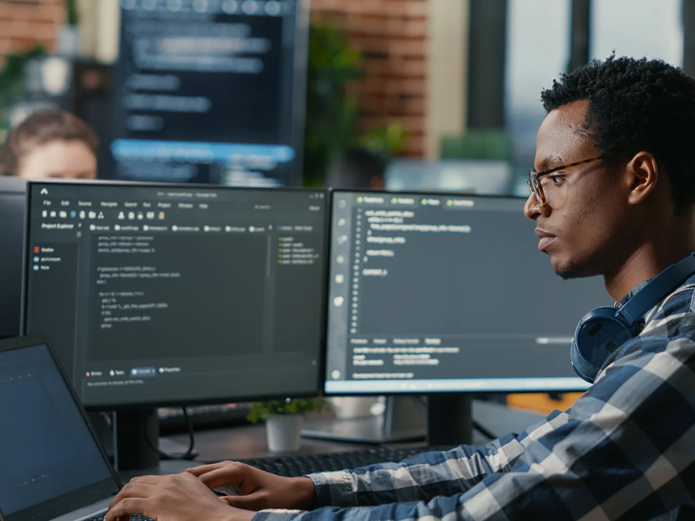 Developer reviewing pipeline code across multiple screens