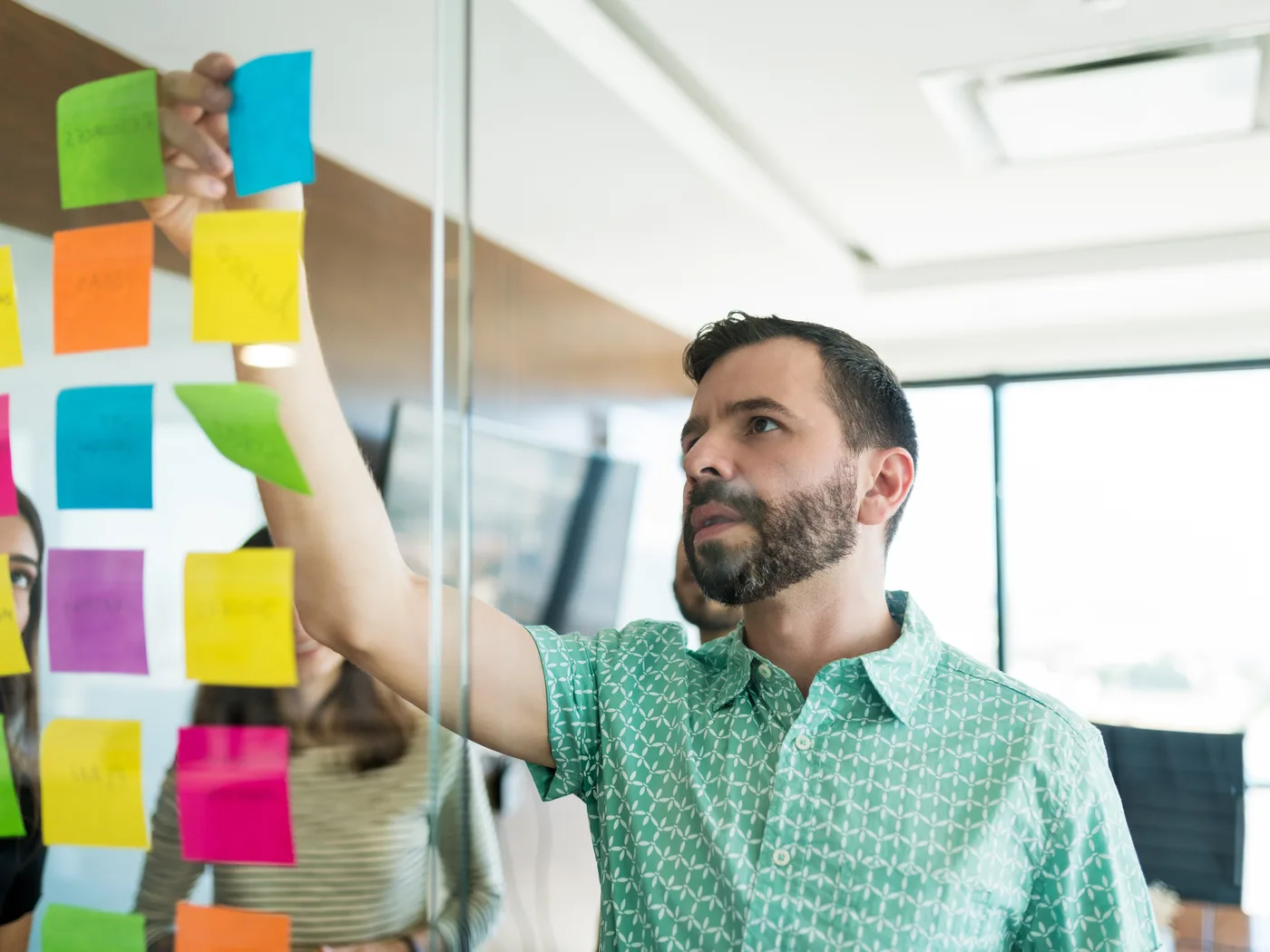 Manager planning an automation roadmap with sticky notes