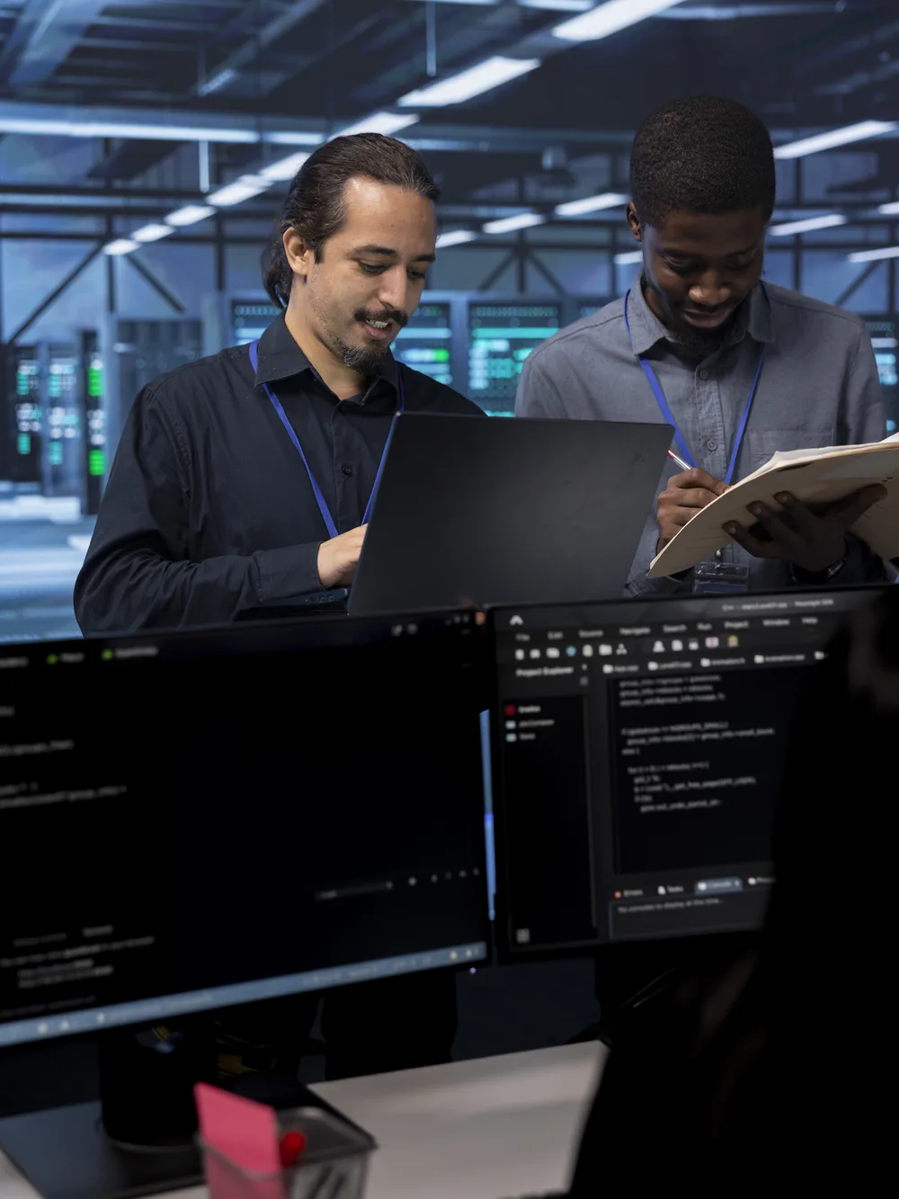 Engineers reviewing systems together in a data centre