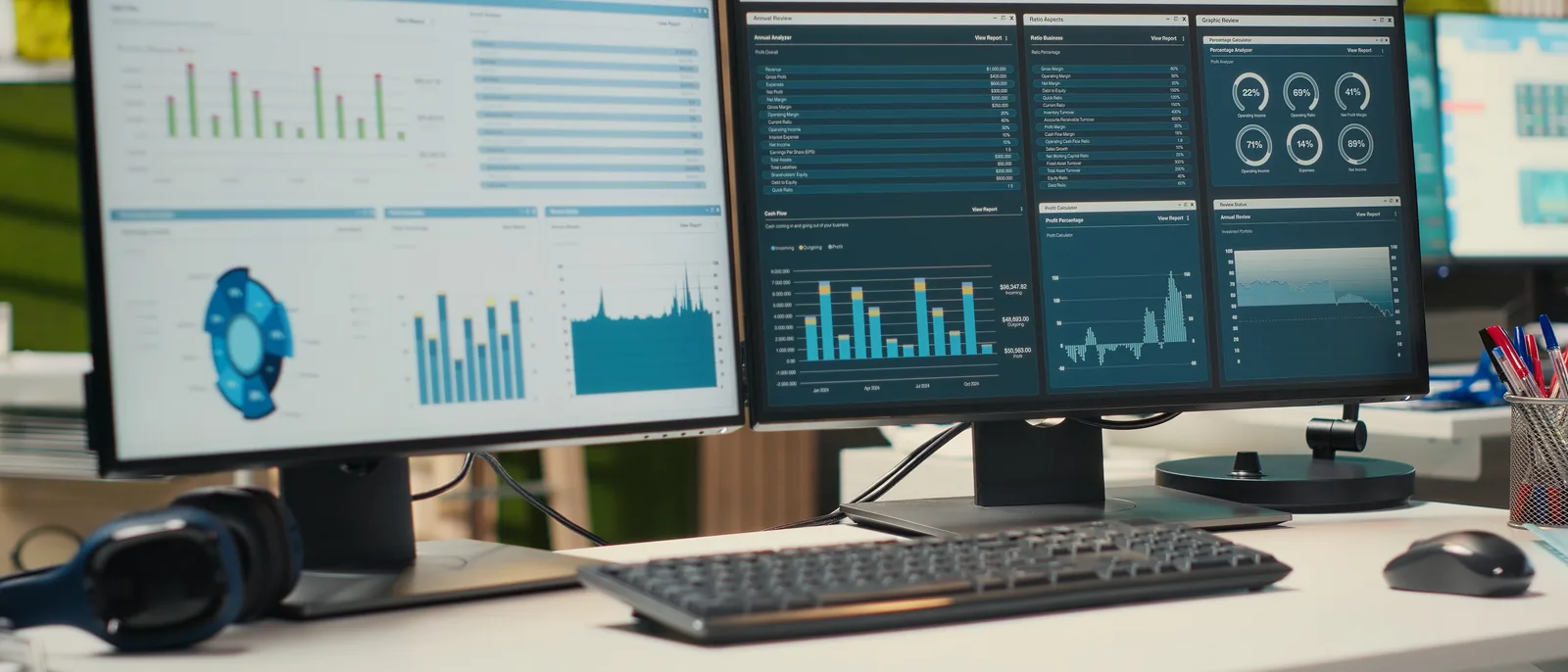 Dual monitors showing test dashboards in a modern office