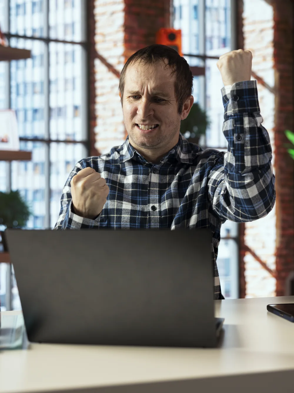 Business user celebrating a positive result at work