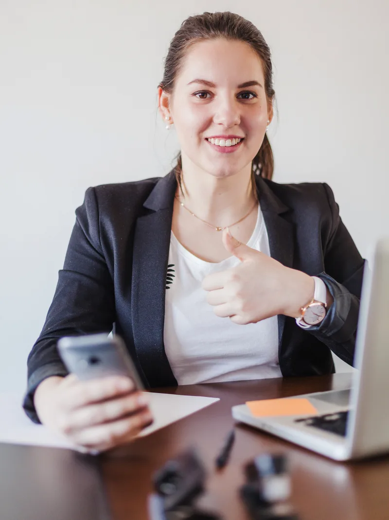 Business user giving the thumbs up after approving evidence